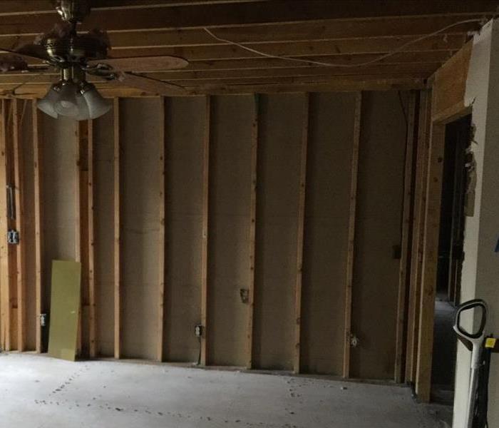 room with wood framing exposed and a ceiling fan