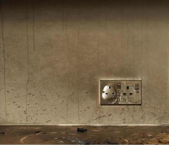 smoke and soot on wall by burned outlet