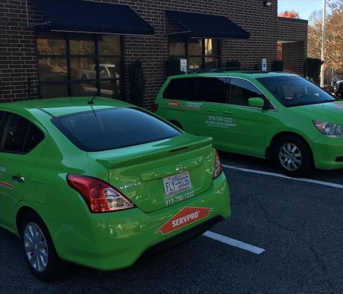 two green SERVPRO cars in a parking lot