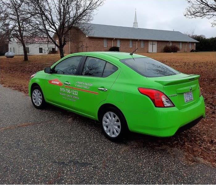 Green SERVPRO car on the side of the road