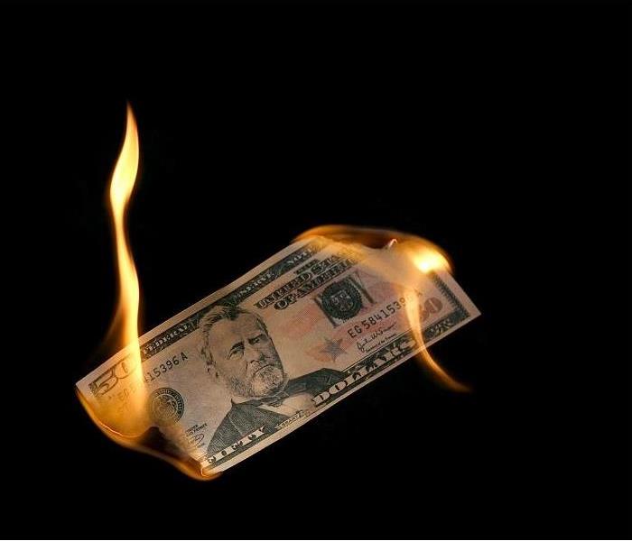 $50 bill burning at both ends