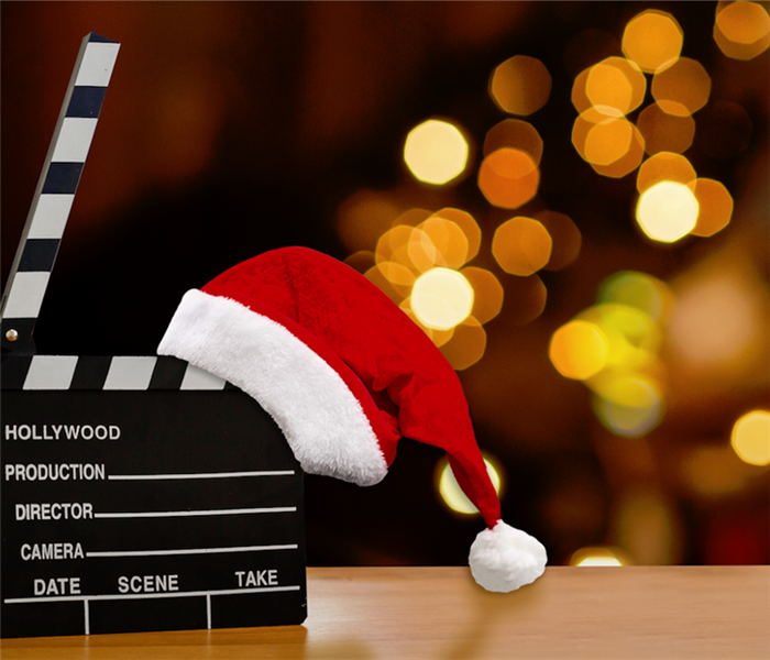 a clapperboard with a Santa hat on it